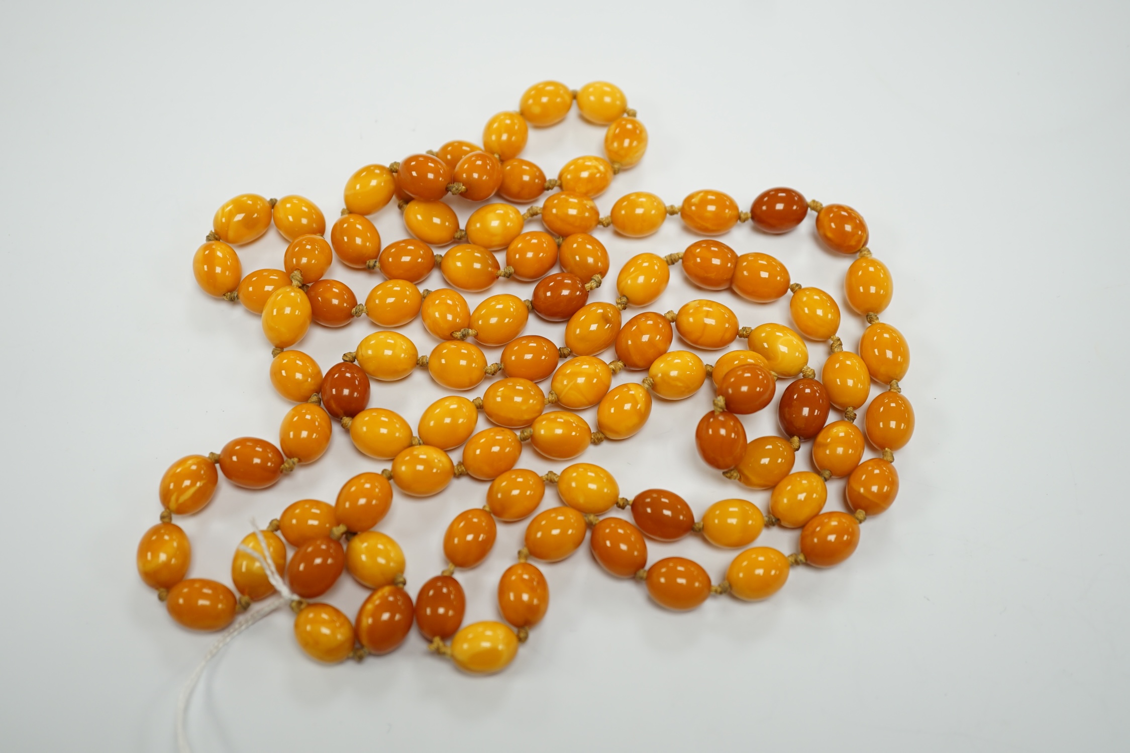 A long single strand oval amber bead necklace, 156cm, gross weight 89 grams. - Image 3 of 9