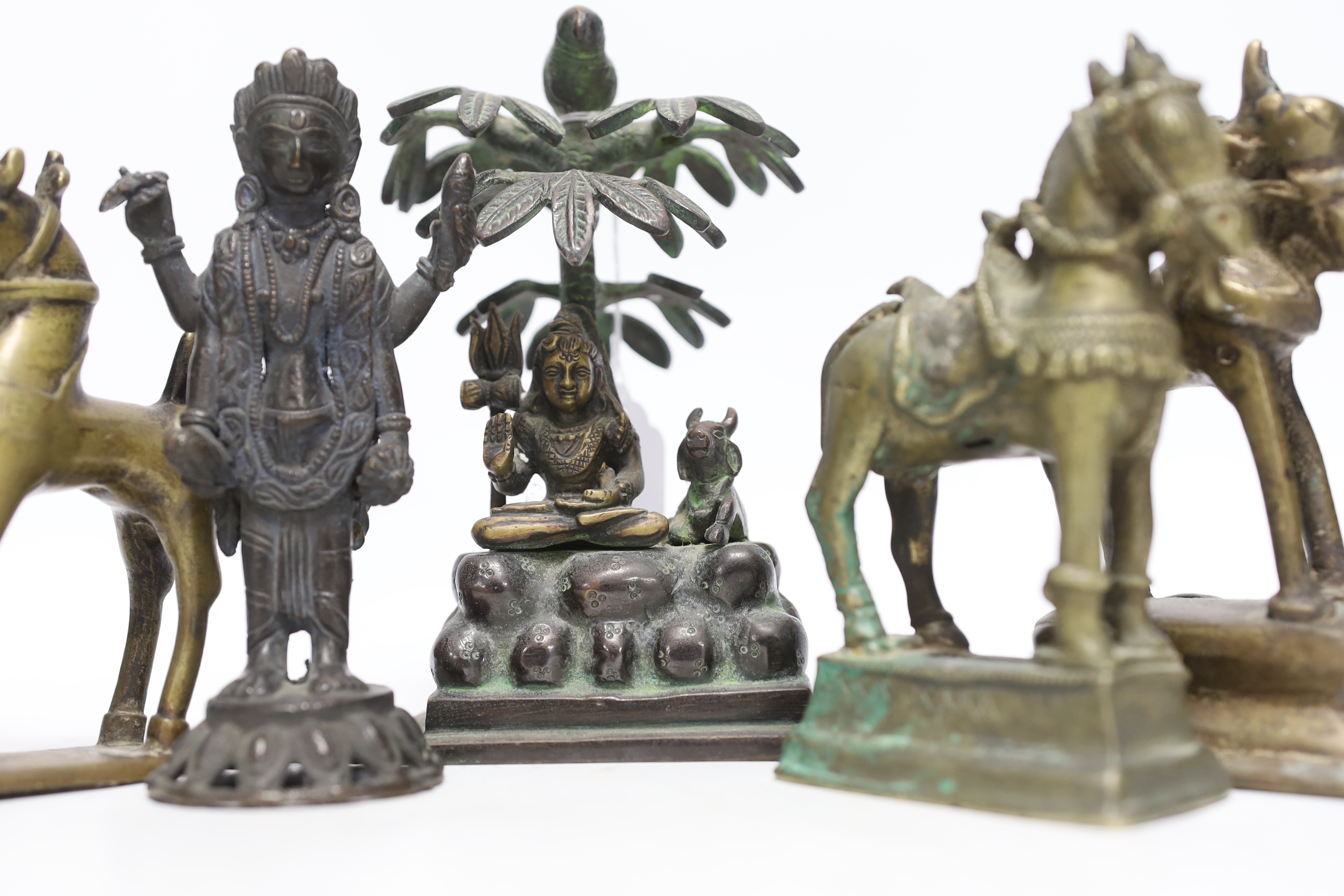 Six Indian bronze/brass ornaments; Shiva sitting under a bael tree with a bird, 17cm, two figures of - Image 4 of 5