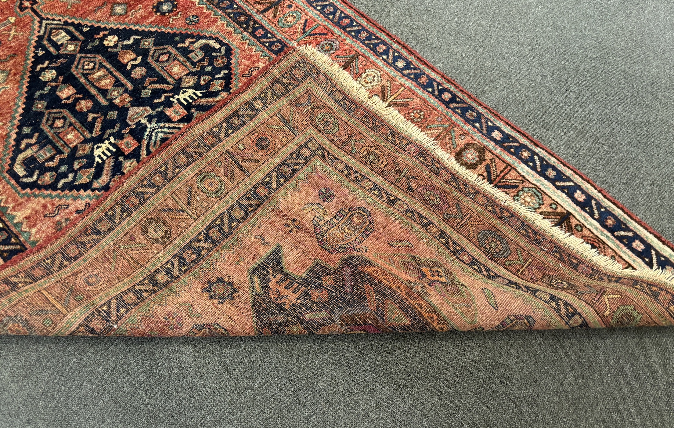 An Heriz red ground medallion rug with triple medallions on a brick red ground, multi bordered, - Image 6 of 7