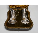 An Edwardian cased silver strawberry and cream set, comprising a cream jug and sugar sifter, by