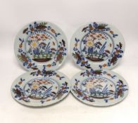 A set of four mid 18th century Delft polychrome floral plates, 22.5cm diameter