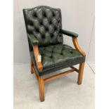 A reproduction buttoned green leather Gainsborough style desk chair, width 59cm, depth 52cm,