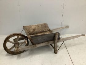 A vintage provincial iron bound wood wheelbarrow, length 180cm