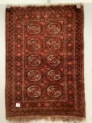 A Bokhara red ground rug, 100 x 72cm