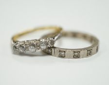 A 750 white metal and diamond chip set full eternity ring and an 18ct and graduated five stone