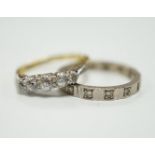 A 750 white metal and diamond chip set full eternity ring and an 18ct and graduated five stone