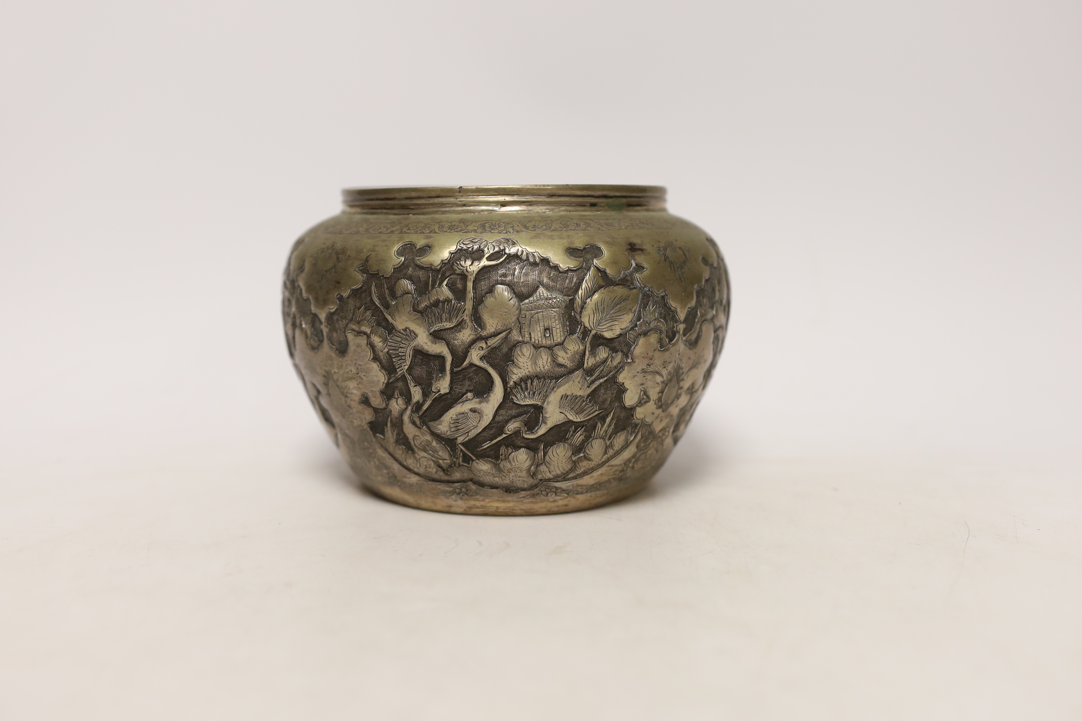 A Persian white metal bowl decorated in relief with animals and flowers, indistinct marks to the - Image 2 of 5
