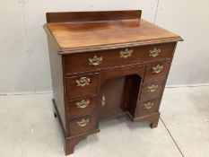 A George III and later mahogany kneehole desk with secretaire drawer, width 85cm, depth 52cm, height