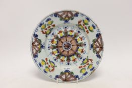 An 18th century Delft floral dish, 22cm in diameter