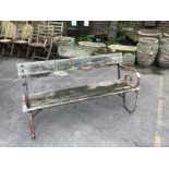 A slatted wrought iron garden bench, width 147cm, height 74cm