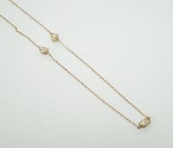 An early 20th century 9ct and eleven stone baroque pearl set long chain, 160cm, gross 13.2 grams.