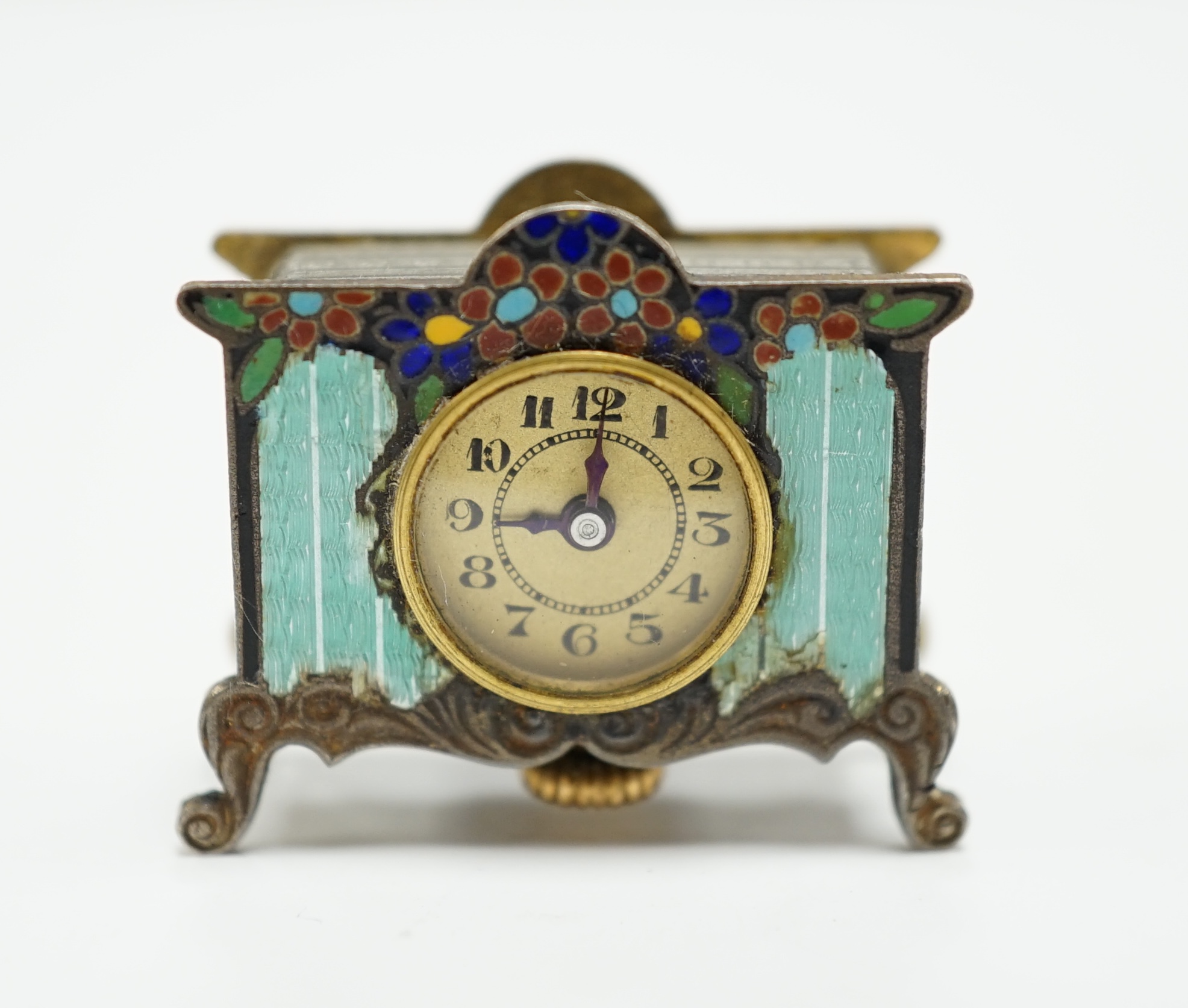 A miniature enamel timepiece modelled as a mantle clock, with watch movement, 2cm high, in fitted