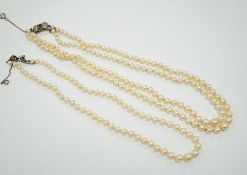 A double strand graduated cultured pearl necklace, with a white metal clasp, 48cm, together with a