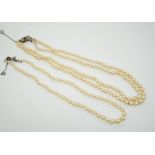 A double strand graduated cultured pearl necklace, with a white metal clasp, 48cm, together with a