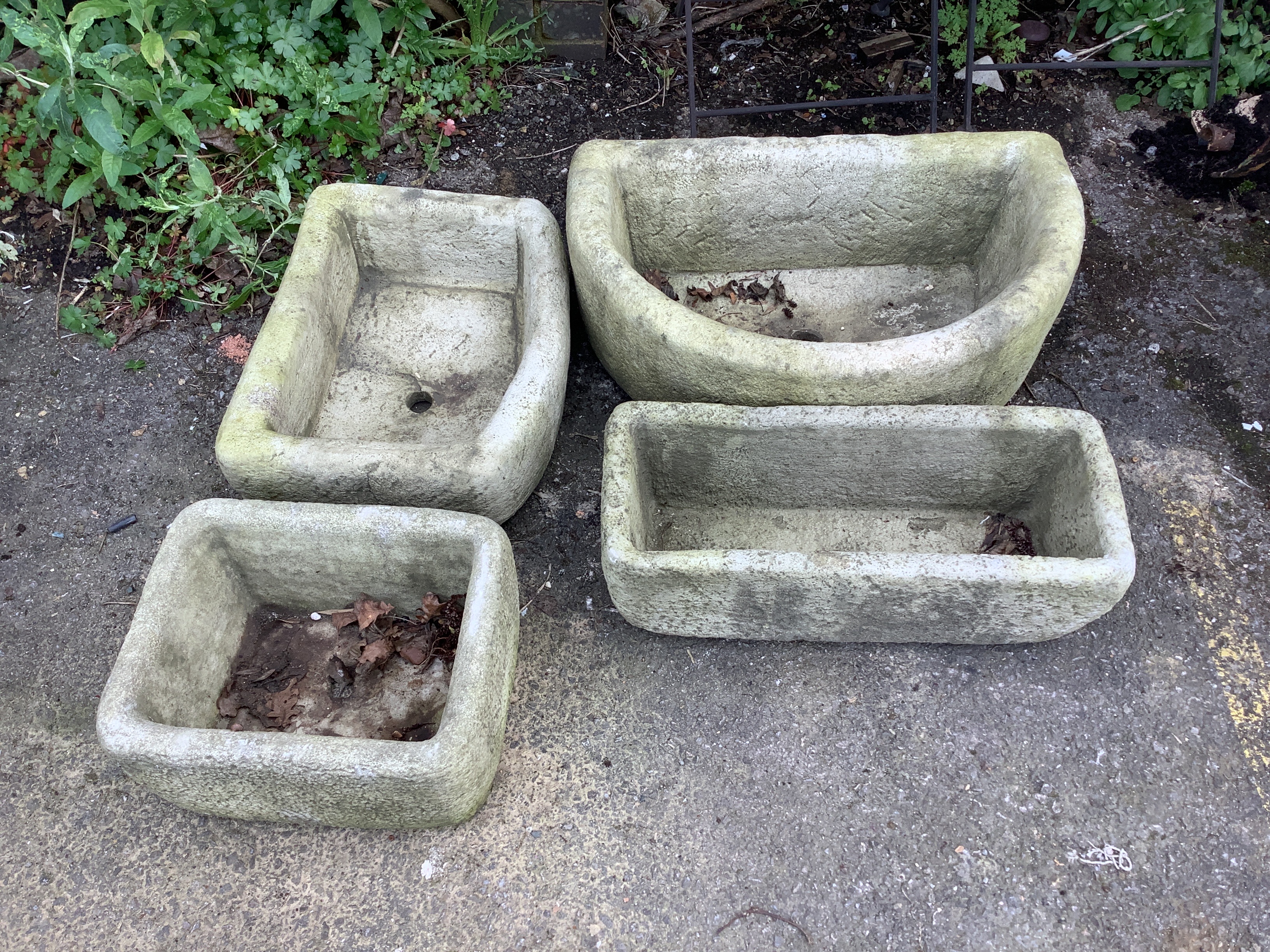 Four cast stone garden planters, largest width 62cm, height 20cm