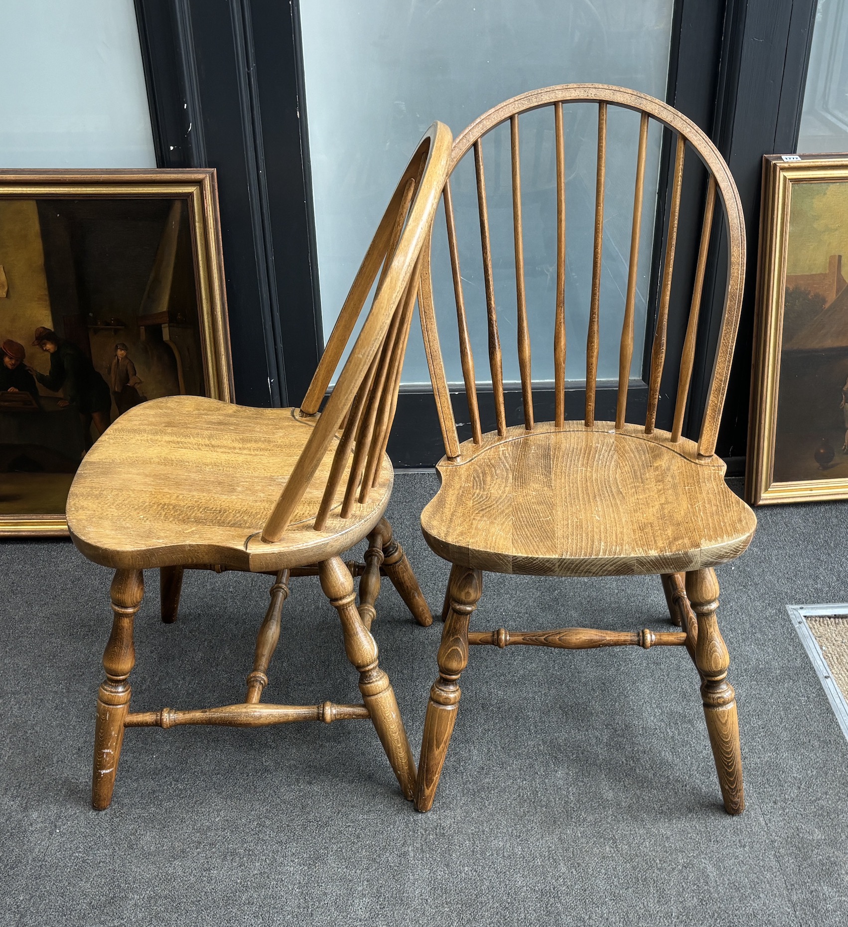 A set of six reproduction Windsor beech comb back dining chairs, two with arms