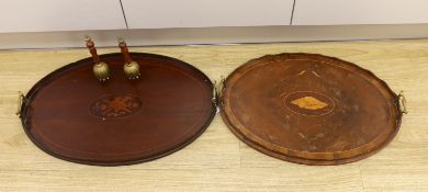 Two oval inlaid Edwardian trays with handles, larger 62cm wide, and two hand bells