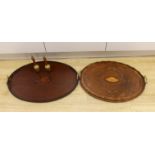 Two oval inlaid Edwardian trays with handles, larger 62cm wide, and two hand bells