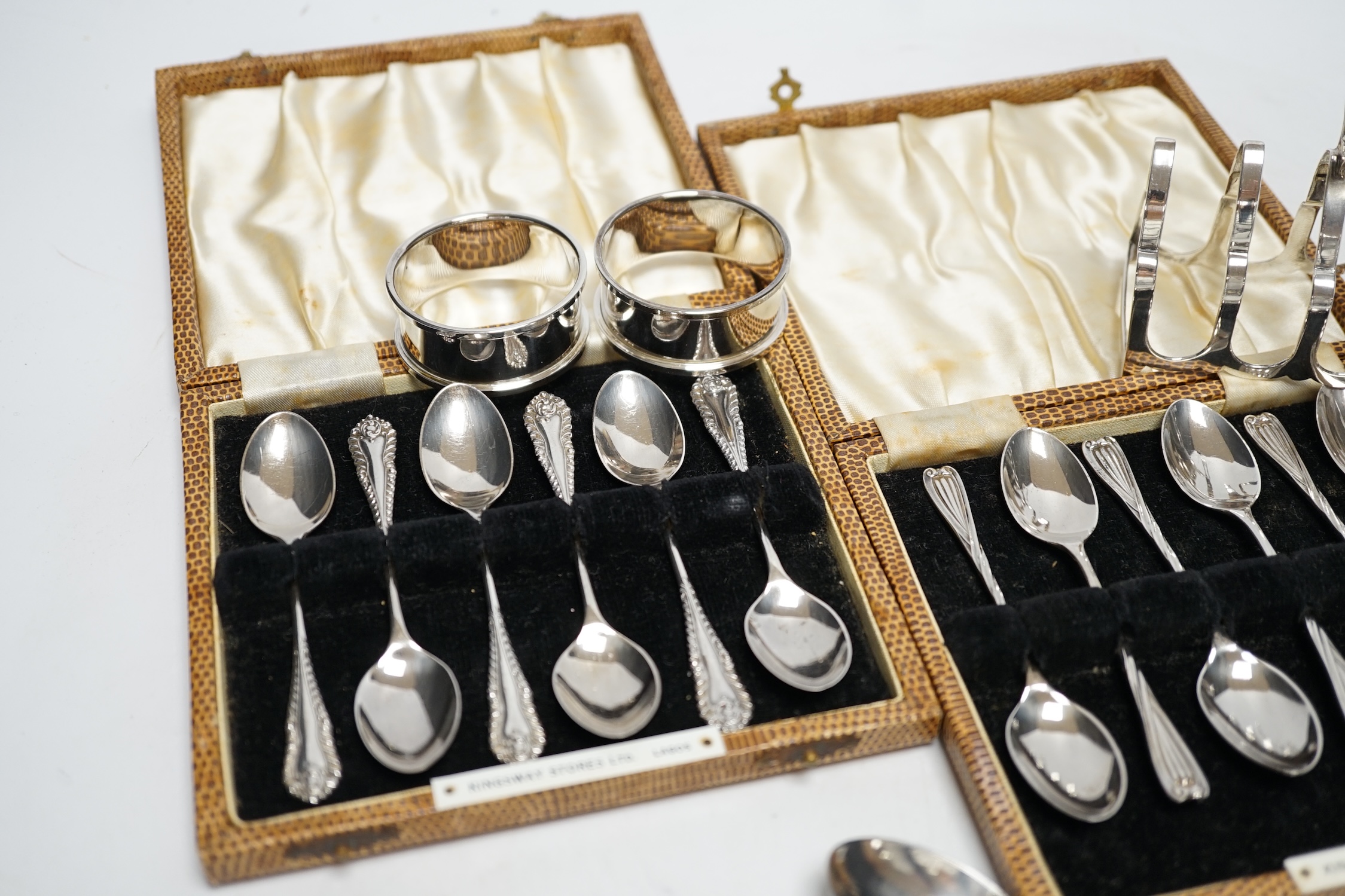 Two cased sets of six silver coffee spoons, a set of four silver condiments, two silver napkin - Image 3 of 6