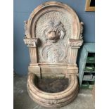 An Italian rose marble garden fountain with lion mask spout, width 94cm, height 135cm