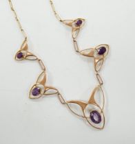 An Edwardian Art Nouveau 9ct and graduated five stone oval cut amethyst set necklace, 44cm, gross
