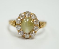 A yellow metal, cat's eye chrysoberyl and diamond cluster set ring, size L, gross weight 2.9 grams.