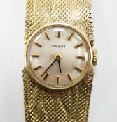 A lady's 9ct gold Tissot manual wind wrist watch, on a 9ct bracelet, 16cm, gross weight 27.9 grams.