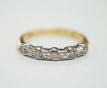 A modern 18ct gold, round and baguette cut diamond set half hoop ring, size N/O, gross weight 3.2