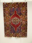 A Turkish purple ground rug, 157 x 109cm