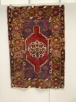 A Turkish purple ground rug, 157 x 109cm