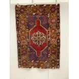 A Turkish purple ground rug, 157 x 109cm