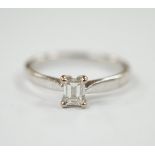 A modern 18ct white gold and solitaire emerald cut diamond set ring, size Q, gross weight 3.4