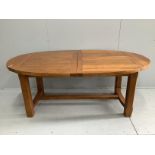 A contemporary oval oak extending dining table, 270cm extended, two spare leaves, depth 110cm,