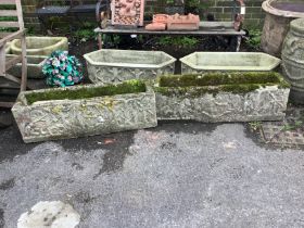 A pair of rectangular reconstituted stone garden trough planters, moulded with classical figures,