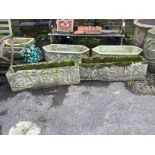 A pair of rectangular reconstituted stone garden trough planters, moulded with classical figures,