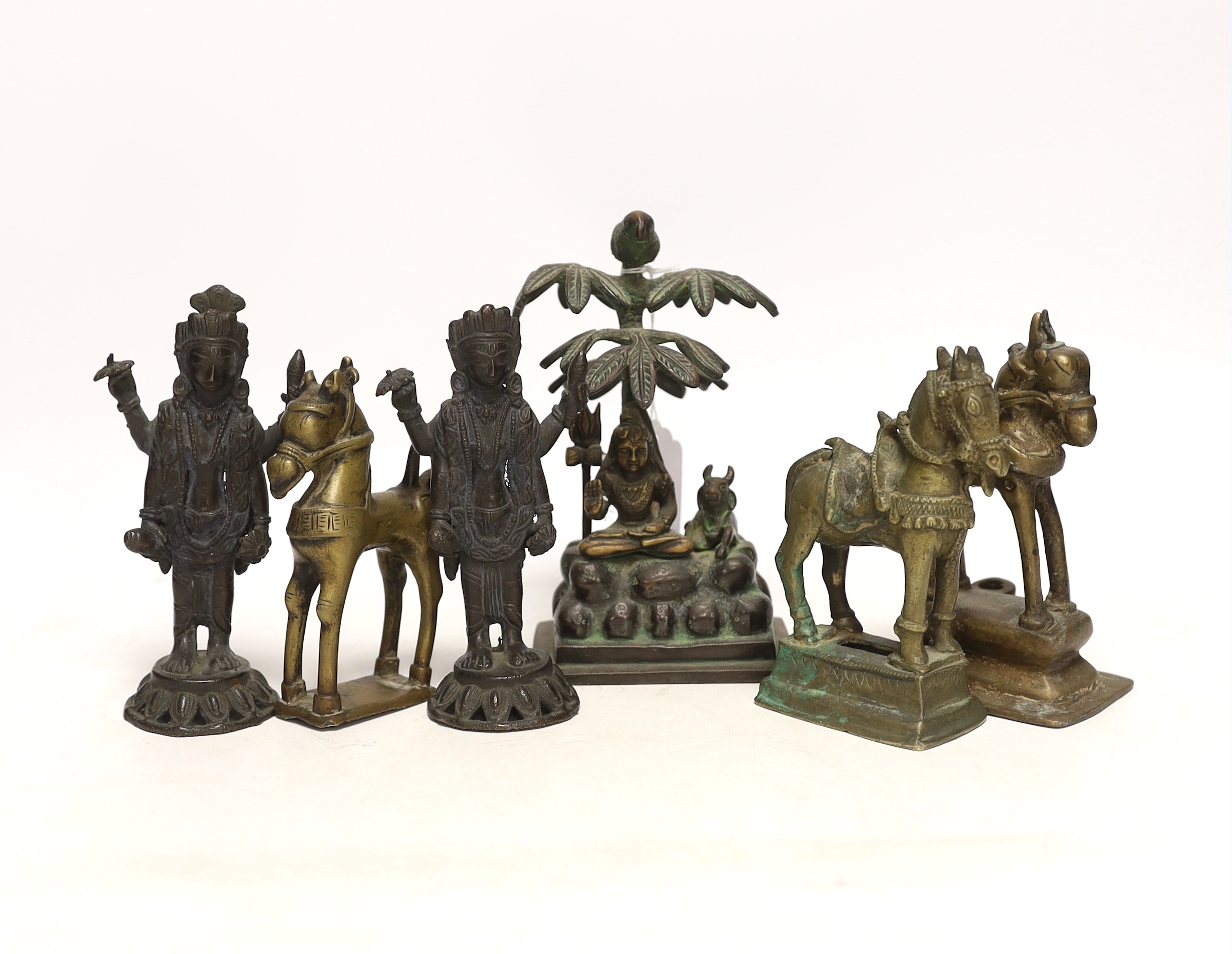 Six Indian bronze/brass ornaments; Shiva sitting under a bael tree with a bird, 17cm, two figures of