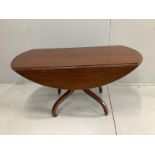 A Regency mahogany oval drop leaf dining table, width 140cm, depth 64cm, height 73cm