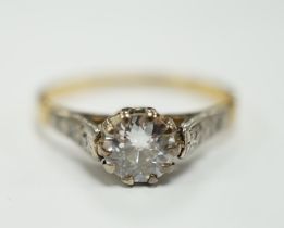 An 18ct, plat and single stone diamond set ring, with diamond chip set shoulders, the stone weighing