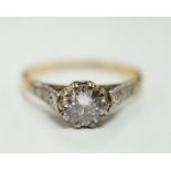 An 18ct, plat and single stone diamond set ring, with diamond chip set shoulders, the stone weighing