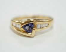 A modern 14ct and single stone tanzanite and graduated eight stone baguette cut diamond set ring,
