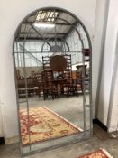 A large industrial style metal mounted arched garden window frame wall mirror, width 90cm, height