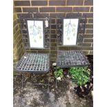 A pair of folding painted metal garden chairs with lattice seats