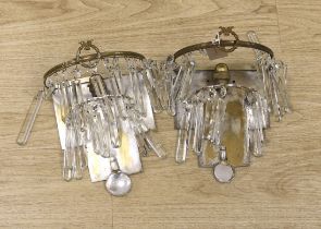 A set of four metal wall lights, three suspended with cut glass lustres