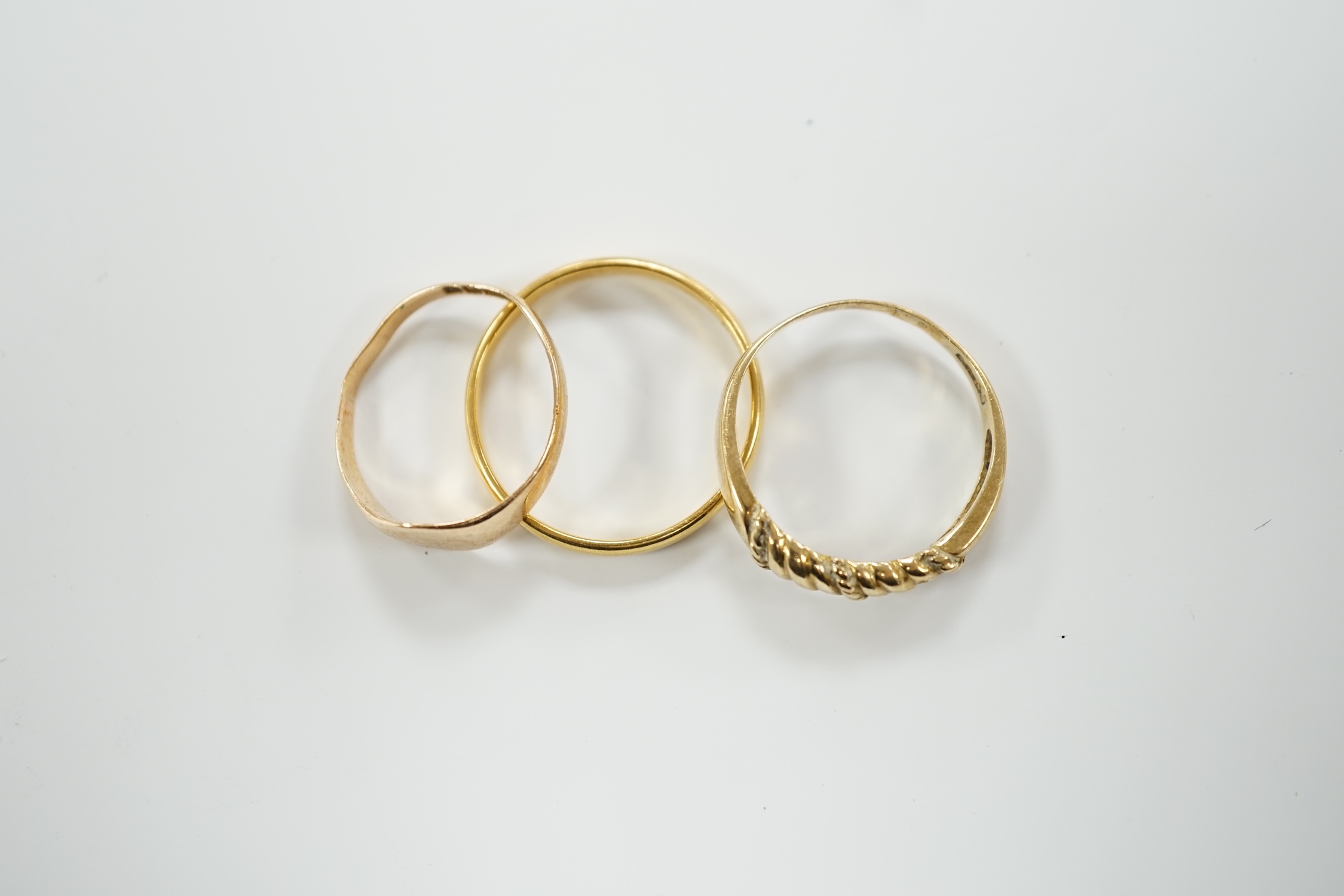 A 22ct gold wedding band, 3.4 grams, a 9ct gold signet ring, 16 grams and a yellow metal ring. - Image 2 of 4