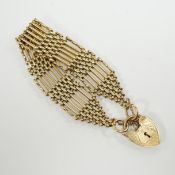 A 1960's 9ct gold gate link bracelet, with heart shaped padlock clasp, 17cm, 31.3 grams.