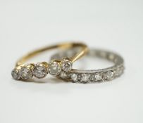 A white metal and diamond chip set full eternity ring and an 18ct and graduated five stone diamond
