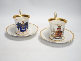 A pair of German porcelain armorial cups and saucers, one saucer reads ‘Lord Bingham s/m Y.