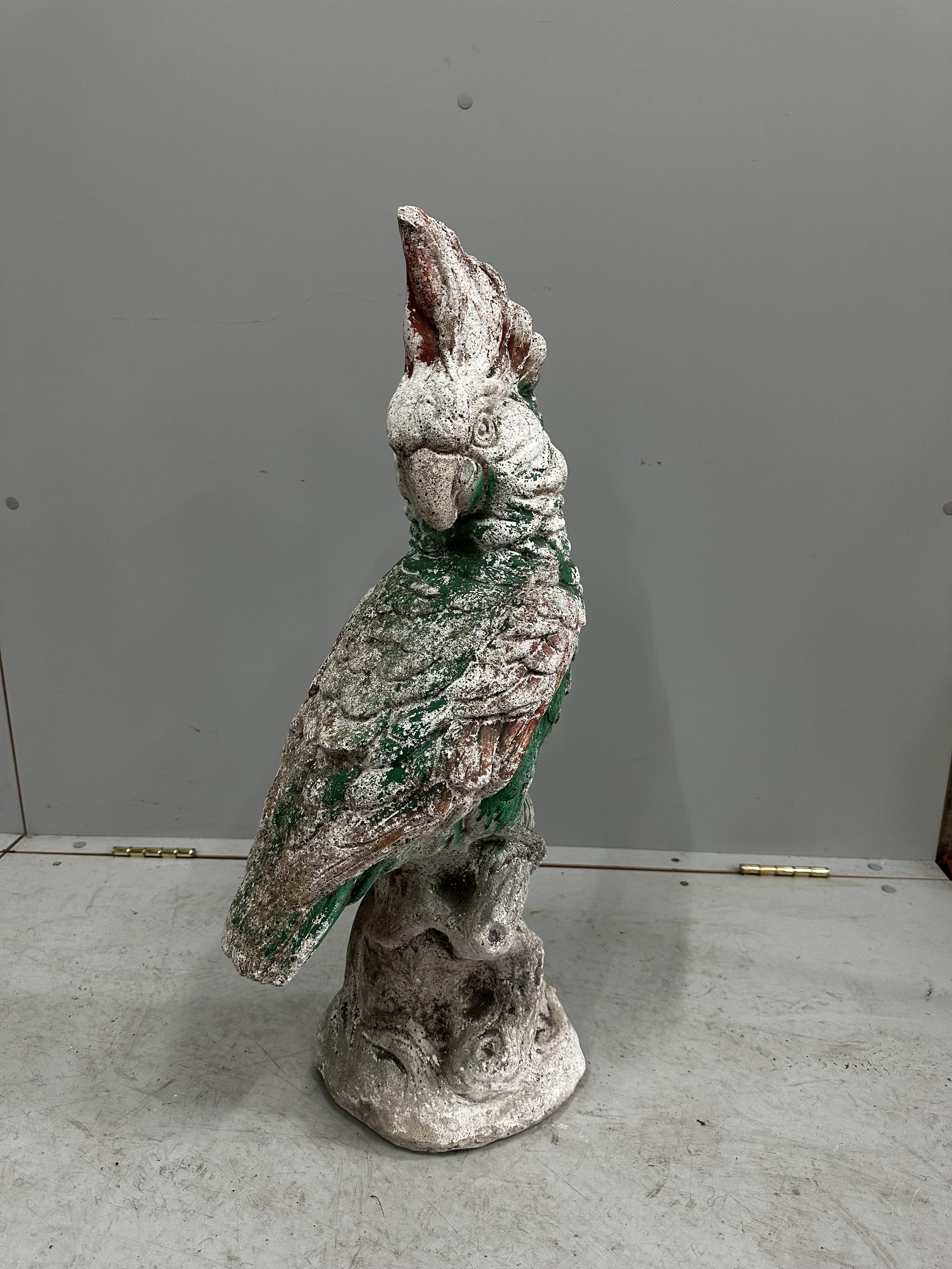 A painted reconstituted stone garden ornament modelled as a parrot, height 74cm