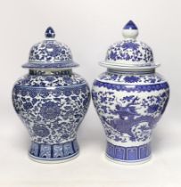 Two Chinese blue and white vases and covers, 38cm high