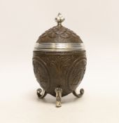 A unmarked white metal mounted coconut cup, on three scroll feet, height 17.4cm.